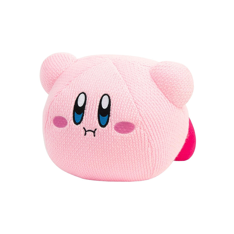 A pink textured plush toy shaped like Kirby, featuring embroidered blue eyes, pink cheeks, and a small red tail, isolated on a white background.