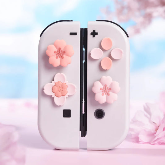 White gaming controllers with pink floral designs on a soft pink background